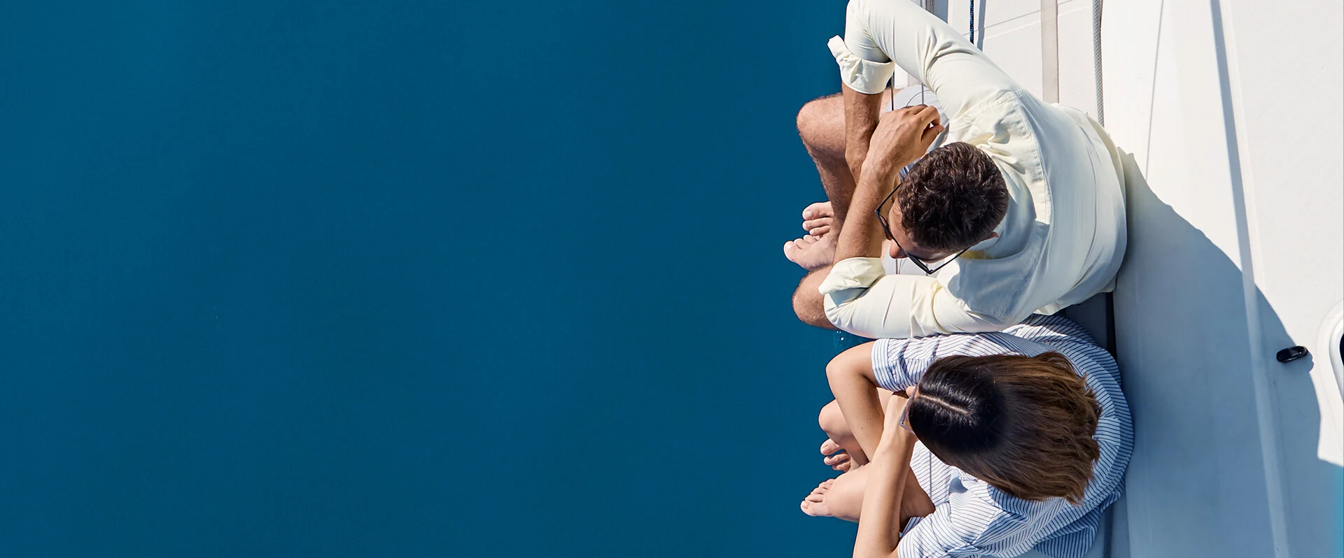 Guests relaxing at the edge of the yacht above the Ionian Sea