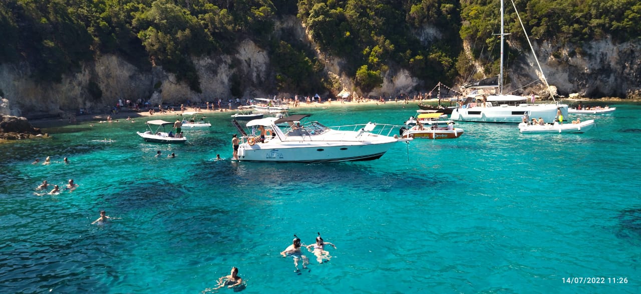 Almyra and swimmers in a secluded emerald cove